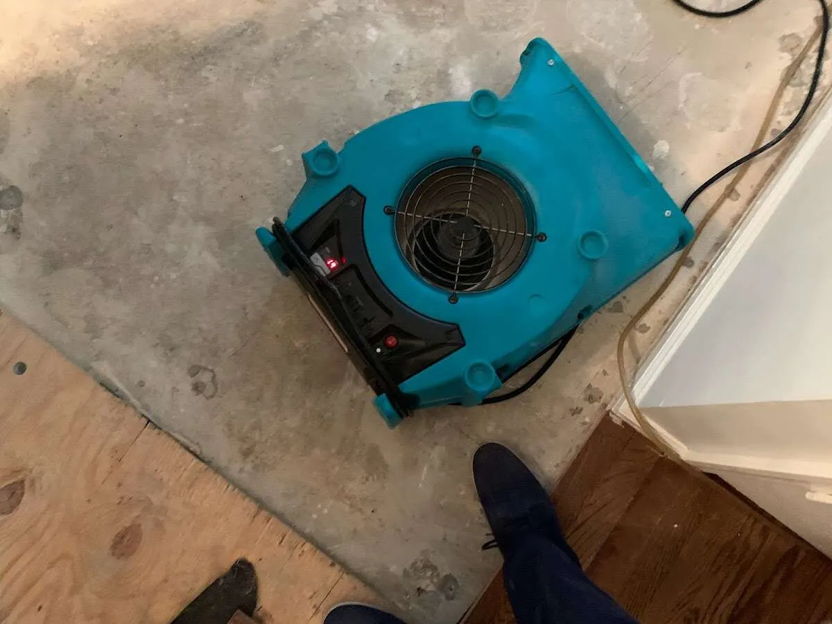 Air mover drying subfloor during Commercial Water Damage Restoration in Weston